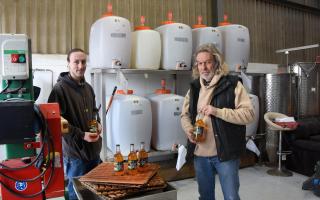 Russell Watson and his son, Archie, by their press and tanks at East Norfolk Cider, Scratby, with their award-winning Normal 4pc Norfolk cider.