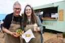 Gary Arlow and his daughter Joely Carter with loaded fries and a cake from Birdys Bakehouse at Blakeney Quay. Picture: Newsquest