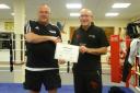 Tyrone Harold receiving his AIBA 1 Star coaching certificate from Cecil Page, a Kingfisher coach and former boxer for the club. Picture:Tony Blencowe.