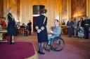 Wheelchair tennis ace Alfie Hewett (right) received his OBE from the Princess Royal on Tuesday. Picture - PA Wire