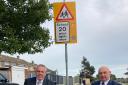 County Councillors Carl Smith and Carl Annison at one of the new 20mph signs in Bradwell.