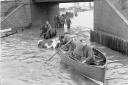 People row a boat in floodwaters in Cobholm in Great Yarmouth in 1953.