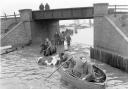 People row a boat in floodwaters in Cobholm in Great Yarmouth in 1953.