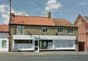 A developer has been given permission to build four new apartments behind the Well Pharmacy on The Street in Acle.