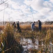 Researchers coring into deep peat soils in the Broads