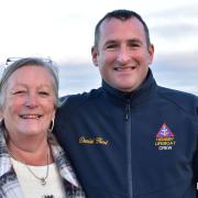 Sue Weaver (pictured with Hemsby Lifeboat coxswain Daniel Hurd) has raised £30,000 for the Lifeboat in 2023. Picture - Newsquest