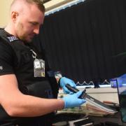 Dereham police carry out a drugs raid on a property in Sandy Lane. PC Stu Lyle with a knife he has found. Picture: DENISE BRADLEY