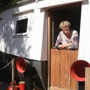 Sally Bransom with her 1893 lifeboat which she has converted into a holiday home in Horsford.