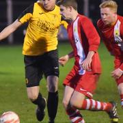 Action from Fakenham's 6-3 defeat against Newmarket, red, on Saturday. Picture: IAN BURT