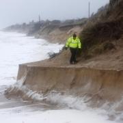 Chris Batten, Hemsby Lifeboat helmsman, makes his way around the eroded beach at Hemsby Gap during the high winds and high tide. Photo: Denise Bradley.