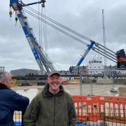 Philip Blake in front the giant crane on the River Yare