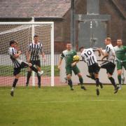 Ran Curtis volleys the third goal against Heacham Picture: David Hardy