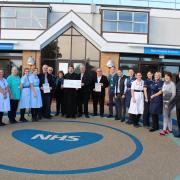 Saint Spyridon church committee presenting a cheque worth £3,000 to the Ward 3 team at the James Paget hospital.