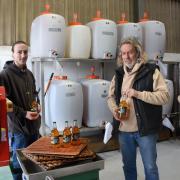 Russell Watson and his son, Archie, by their press and tanks at East Norfolk Cider, Scratby, with their award-winning Normal 4pc Norfolk cider.