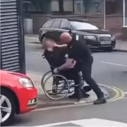 Images show the police officer tackling a man in a wheelchair